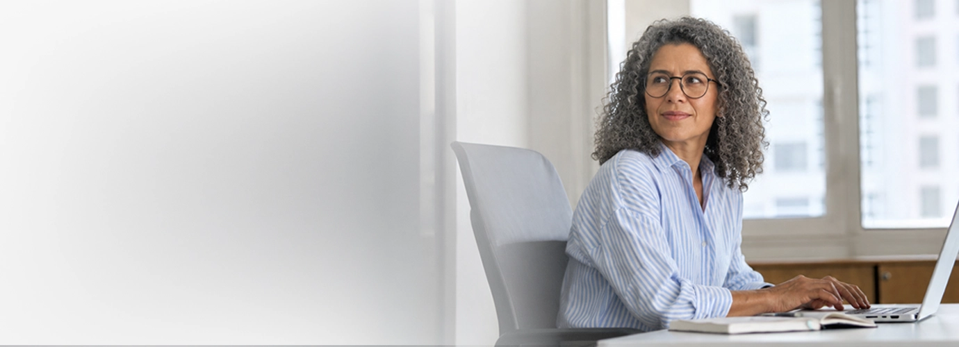 A Hexaware cloud migration engineer sitting at their workdesk